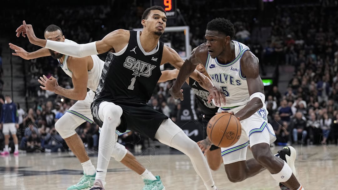 Jan 27, 2024; San Antonio, Texas, USA; Minnesota Timberwolves guard Anthony Edwards (5) drives to the basket against San Antonio Spurs forward Victor Wembanyama (1) during the second half at Frost Bank Center. Mandatory Credit: Scott Wachter-Imagn Images