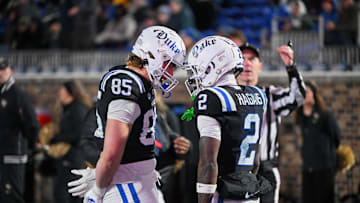 Nov 29, 2025; Durham, North Carolina, USA;   Duke Blue Devils wide receiver Sahmir Hagans (2) celebrates with tight end Jeremiah Hasley (85) after scoring a touchdown against the Wake Forest Demon Deacons during the third quarter at Wallace Wade Stadium. Mandatory Credit: Zachary Taft-Imagn Images