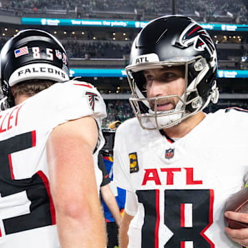 Sep 16, 2024; Philadelphia, Pennsylvania, USA; Atlanta Falcons quarterback Kirk Cousins (18) hugs tight end Ross Dwelley (85) after a victory against the Philadelphia Eagles at Lincoln Financial Field. Mandatory Credit: Bill Streicher-Imagn Images