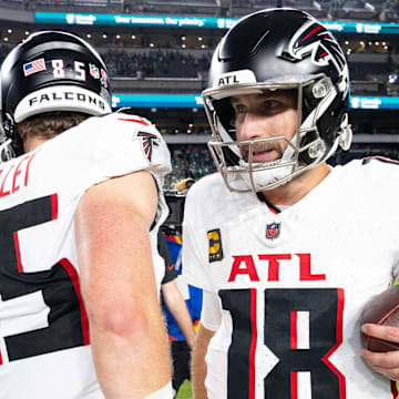 Sep 16, 2024; Philadelphia, Pennsylvania, USA; Atlanta Falcons quarterback Kirk Cousins (18) hugs tight end Ross Dwelley (85) after a victory against the Philadelphia Eagles at Lincoln Financial Field. Mandatory Credit: Bill Streicher-Imagn Images