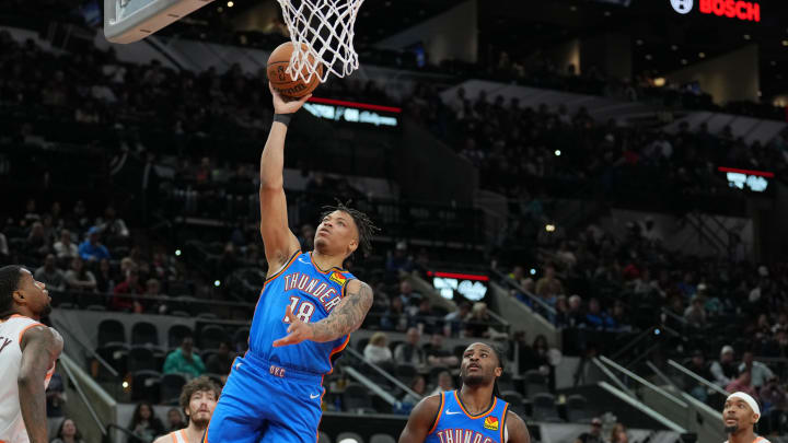 Jan 24, 2024; San Antonio, Texas, USA;  Oklahoma City Thunder forward Keyontae Johnson (18) shoots in front of San Antonio Spurs guard Blake Wesley (14) in the second  half at Frost Bank Center. Mandatory Credit: Daniel Dunn-USA TODAY Sports