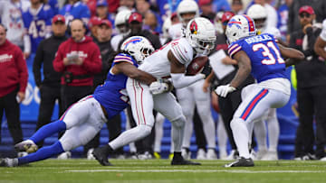 Sep 8, 2024; Orchard Park, New York, USA; Buffalo Bills linebacker Dorian Williams (42) and Buffalo Bills cornerback Rasul Douglas (31) tackle Arizona Cardinals wide receiver Marvin Harrison Jr. (18) during the first half at Highmark Stadium. Mandatory Credit: Gregory Fisher-Imagn Images