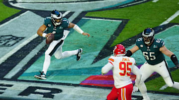 Feb 12, 2023; Glendale, AZ, USA; Philadelphia Eagles quarterback Jalen Hurts (1) runs the ball as he is pressured by Kansas City Chiefs defensive tackle Chris Jones (95) during the first half in Super Bowl LVII at State Farm Stadium. Mandatory Credit: Patrick Breen/The Republic via Imagn Images