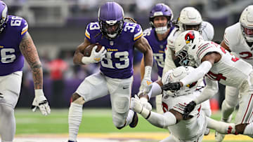 Dec 1, 2024; Minneapolis, Minnesota, USA; Minnesota Vikings safety Harrison Smith (22) runs the ball as Arizona Cardinals defensive tackle Dante Stills (rear) and safety Jalen Thompson (34) go to make the tackle during the first quarter at U.S. Bank Stadium. Mandatory Credit: Jeffrey Becker-Imagn Images