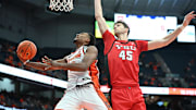 Nov 16, 2024; Syracuse, New York, USA; Syracuse Orange guard J.J. Starling (2) goes for a lay up as Youngstown State Penguins center Gabe Dynes (45) defends in the second half at the JMA Wireless Dome. Mandatory Credit: Mark Konezny-Imagn Images