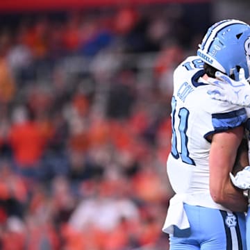 Oct 31, 2025; Syracuse, New York, USA; North Carolina Tar Heels running back Demon June (12) is greeted by tight end Conner Cox (81) after scoring a touchdown in the third quarter against the Syracuse Orange at the JMA Wireless Dome. 