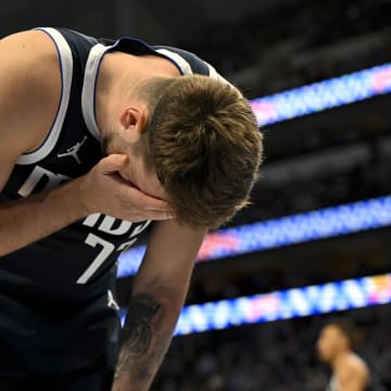 Dec 12, 2023; Dallas, Texas, USA; Dallas Mavericks guard Luka Doncic (77) is hit in the face as he battles for the rebound against the Los Angeles Lakers during the first quarter at the American Airlines Center. Mandatory Credit: Jerome Miron-USA TODAY Sports