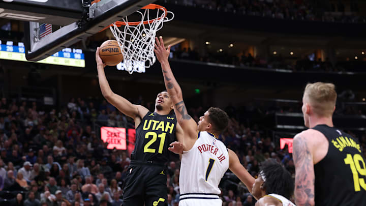 Apr 9, 2024; Salt Lake City, Utah, USA; Utah Jazz forward Darius Bazley (21) goes to the basket against Denver Nuggets forward Michael Porter Jr. (1) during the fourth quarter at Delta Center. Mandatory Credit: Rob Gray-Imagn Images