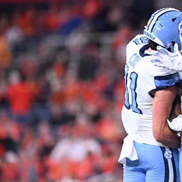 Oct 31, 2025; Syracuse, New York, USA; North Carolina Tar Heels running back Demon June (12) is greeted by tight end Conner Cox (81) after scoring a touchdown in the third quarter against the Syracuse Orange at the JMA Wireless Dome. Mandatory Credit: Mark Konezny-Imagn Images