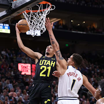 Apr 9, 2024; Salt Lake City, Utah, USA; Utah Jazz forward Darius Bazley (21) goes to the basket against Denver Nuggets forward Michael Porter Jr. (1) during the fourth quarter at Delta Center. Mandatory Credit: Rob Gray-Imagn Images