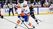 Jan 11, 2025; Salt Lake City, Utah, USA; New York Islanders center Brock Nelson (29) takes a shot against Utah Hockey Club center Barrett Hayton (27) during first period at the Delta Center. Mandatory Credit: Christopher Creveling-Imagn Images