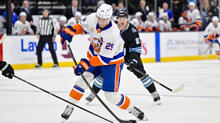 Jan 11, 2025; Salt Lake City, Utah, USA; New York Islanders center Brock Nelson (29) takes a shot against Utah Hockey Club center Barrett Hayton (27) during first period at the Delta Center. Mandatory Credit: Christopher Creveling-Imagn Images