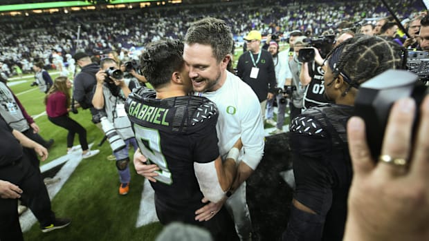 Oregon Ducks head coach Dan Lanning hugs quarterback Dillon Gabriel
