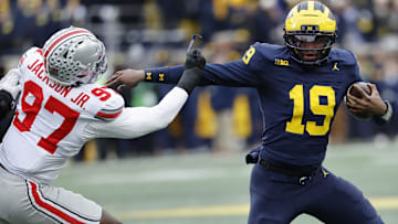 Nov 29, 2025; Ann Arbor, Michigan, USA; Michigan Wolverines quarterback Bryce Underwood (19) runs the ball defended by Ohio State Buckeyes defensive end Kenyatta Jackson Jr. (97) in the first half at Michigan Stadium. Mandatory Credit: Rick Osentoski-Imagn Images