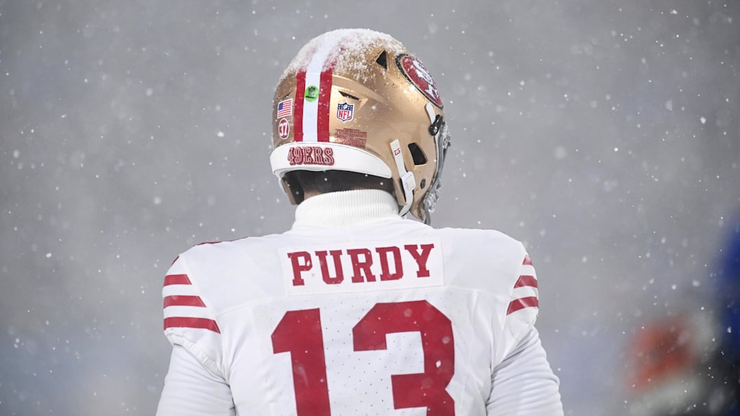 Dec 1, 2024; Orchard Park, New York, USA; Snow sits on top of the helmet of San Francisco 49ers quarterback Brock Purdy (13) in the fourth quarter game against the Buffalo Bills at Highmark Stadium. Mandatory Credit: Mark Konezny-Imagn Images