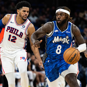 Jan 19, 2024; Orlando, Florida, USA; Orlando Magic guard Kevon Harris (8) dribbles the ball against Philadelphia 76ers forward Tobias Harris (12) in the fourth quarter at KIA Center. Mandatory Credit: Jeremy Reper-Imagn Images