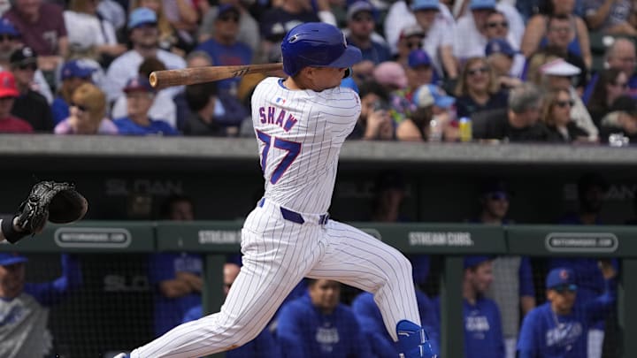 Feb 23, 2024; Mesa, Arizona, USA; Chicago Cubs second baseman Matt Shaw (77) hits an RBI double against the Chicago White Sox in the first inning at Sloan Park. 