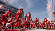 The Utah Utes run out on the field before the game against the Baylor Bears at Rice-Eccles Stadium.