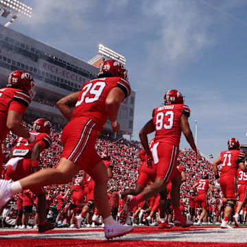 The Utah Utes run out on the field before the game against the Baylor Bears at Rice-Eccles Stadium.