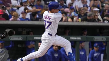 Feb 23, 2024; Mesa, Arizona, USA; Chicago Cubs second baseman Matt Shaw (77) hits an RBI double against the Chicago White Sox in the first inning at Sloan Park. 