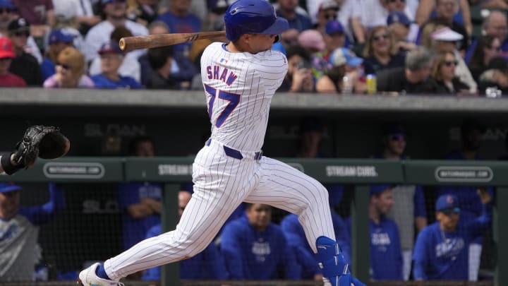 Feb 23, 2024; Mesa, Arizona, USA; Chicago Cubs second baseman Matt Shaw (77) hits an RBI double against the Chicago White Sox in the first inning at Sloan Park. Mandatory Credit: Rick Scuteri-USA TODAY Sports