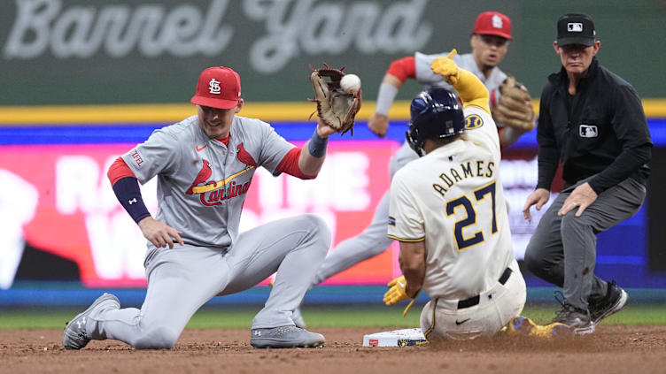 May 9, 2024; Milwaukee, Wisconsin, USA;  Milwaukee Brewers shortstop Willy Adames (27) steals second base as the ball gets away from St. Louis Cardinals second baseman Nolan Gorman (16) during the third inning at American Family Field. Mandatory Credit: Jeff Hanisch-USA TODAY Sports