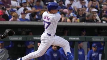 Feb 23, 2024; Mesa, Arizona, USA; Chicago Cubs second baseman Matt Shaw (77) hits an RBI double against the Chicago White Sox in the first inning at Sloan Park.