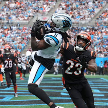 Sep 29, 2024; Charlotte, North Carolina, USA;  Carolina Panthers wide receiver Diontae Johnson (5) attempts catch as Cincinnati Bengals cornerback Dax Hill (23) defends in the first quarter at Bank of America Stadium. Mandatory Credit: Bob Donnan-Imagn Images