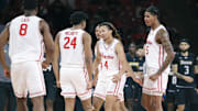 Nov 8, 2025; Houston, Texas, USA; Houston Cougars guard Kingston Flemings (4) celebrates with teammates after scoring during the second half against the Towson Tigers at Fertitta Center. Mandatory Credit: Troy Taormina-Imagn Images