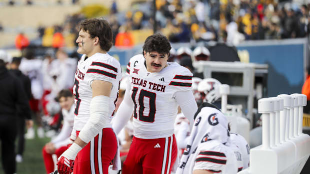 Texas Tech Red Raiders linebacker Jacob Rodriguez talks with quarterback Behren Morton.