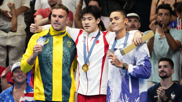 Zhanle Pan accepts his gold medal alongside other medal winners. 