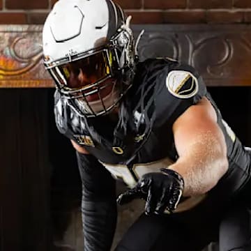 Bryce Boettcher poses in the "ShoeDuck" uniform in front of the Jaqua Ranch fireplace.
