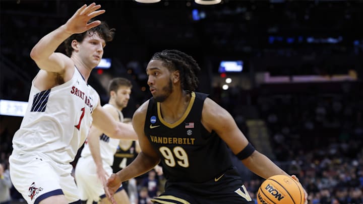 Mar 21, 2025; Cleveland, OH, USA; Vanderbilt Commodores forward Devin McGlockton (99) plays the ball defended by St. Mary's Gaels center Harry Wessels (1) in the second half at Rocket Arena. Mandatory Credit: Rick Osentoski-Imagn Images Mar 21, 2025; Cleveland, OH, USA; Vanderbilt Commodores forward Devin McGlockton (99) plays the ball defended by St. Mary's Gaels center Harry Wessels (1) in the second half at Rocket Arena. Mandatory Credit: Rick Osentoski-Imagn Images
