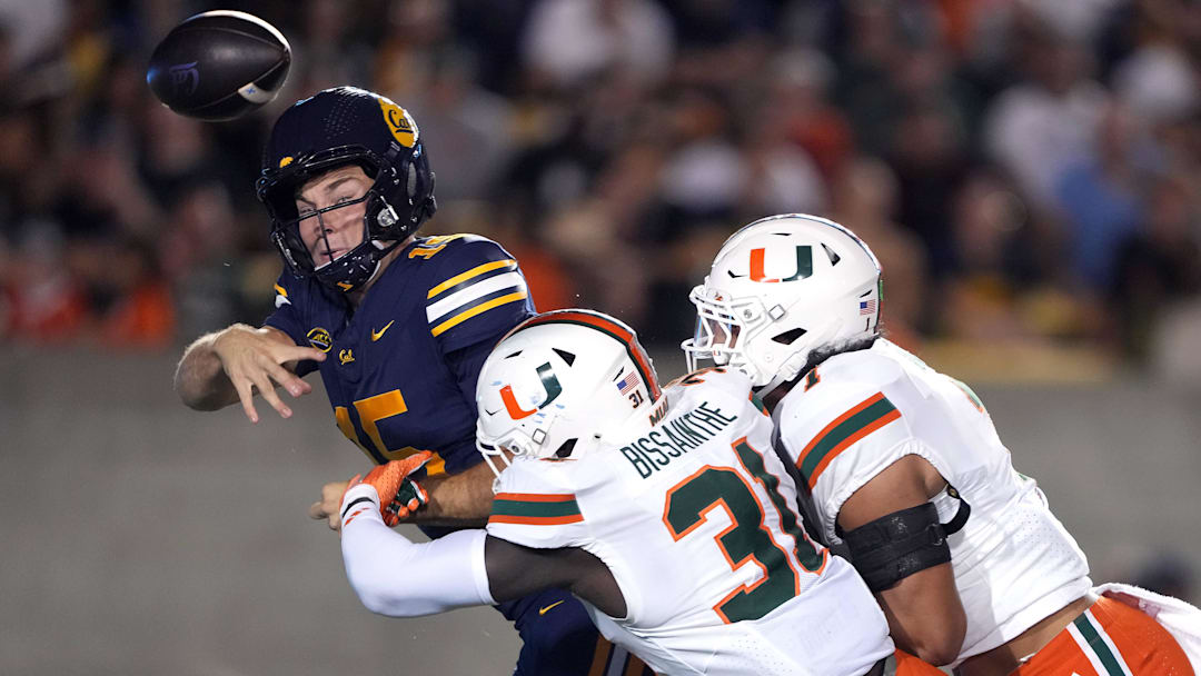 Oct 5, 2024; Berkeley, California, USA; Miami Hurricanes linebacker Wesley Bissainthe (31) and defensive back Jaden Harris (right) force an incomplete pass by California Golden Bears quarterback Fernando Mendoza (left) during the third quarter at California Memorial Stadium. Mandatory Credit: Darren Yamashita-Imagn Images