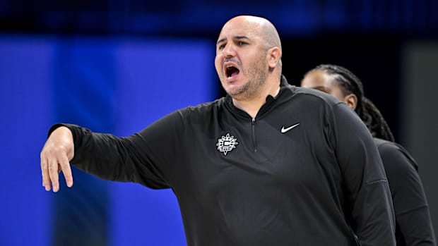 Connecticut Sun head coach Rachid Meziane yells to his team in a black pullover