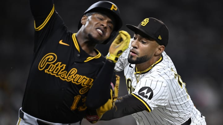 Aug 12, 2024; San Diego, California, USA; Pittsburgh Pirates third baseman Ke'Bryan Hayes (13) is tagged out by San Diego Padres relief pitcher Robert Suarez (75) during the ninth inning at Petco Park. Mandatory Credit: Orlando Ramirez-USA TODAY Sports