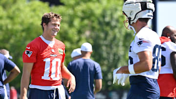 Jul 23, 2025; Foxborough, MA, USA; New England Patriots quarterback Drake Maye (10) and tight end Hunter Henry (85) have a laugh before training camp at Gillette Stadium. Mandatory Credit: Eric Canha-Imagn Images