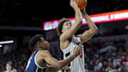 Dec 8, 2024; Cincinnati, Ohio, USA; Cincinnati Bearcats guard Dan Skillings Jr. (0) drives to the basket against Howard Bison forward Cameron Shockley-Okeke (15) in the first half at Fifth Third Arena. Mandatory Credit: Aaron Doster-Imagn Images