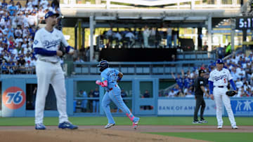 Oct 29, 2025; Los Angeles, California, USA; Toronto Blue Jays first baseman Vladimir Guerrero Jr. (27) runs the bases after hitting a home run in the first inning as Los Angeles Dodgers starting pitcher Blake Snell (7) and first baseman Freddie Freeman (5) watch during game five of the 2025 MLB World Series at Dodger Stadium. Mandatory Credit: Kirby Lee-Imagn Images
