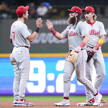 Sep 17, 2024; Milwaukee, Wisconsin, USA;  Philadelphia Phillies left fielder Brandon Marsh (16) greets shortstop Trea Turner (7) following the game against the Milwaukee Brewers at American Family Field.