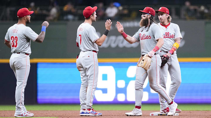 Sep 17, 2024; Milwaukee, Wisconsin, USA;  Philadelphia Phillies left fielder Brandon Marsh (16) greets shortstop Trea Turner (7) following the game against the Milwaukee Brewers at American Family Field.