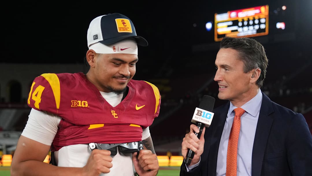Aug 30, 2025; Los Angeles, California, USA; Big Ten Network reporter Rhett Lewis (right) interviews Southern California Trojans quarterback Jayden Maiava (14) after the game against the Missouri State Bears at United Airlines Field at Los Angeles Memorial Coliseum. Mandatory Credit: Kirby Lee-Imagn Images