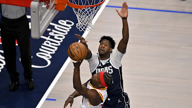 Dallas Mavericks striker, Olivier-Maxence Prosper (8), blocks a blow by the striker of the Golden State Warriors Jimmy Butler (10)