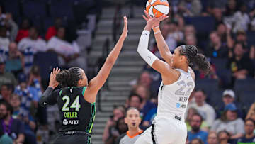 Jul 25, 2025; Minneapolis, Minnesota, USA; Las Vegas Aces center A'ja Wilson (22) shoots against the Minnesota Lynx forward Napheesa Collier (24) in the third quarter at Target Center. Mandatory Credit: Brad Rempel-Imagn Images
