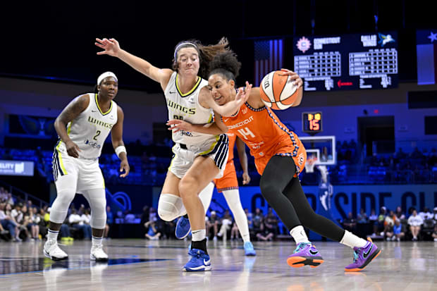 Connecticut Sun guard Bria Hartley is fouled by Dallas Wings forward Maddy Siegrist