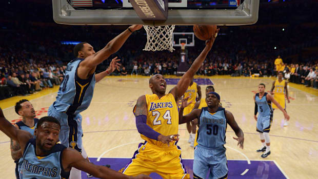 Los Angeles Lakers forward Kobe Bryant (24) shoots the ball while defended by Memphis Grizzlies guard Tony Allen (9)