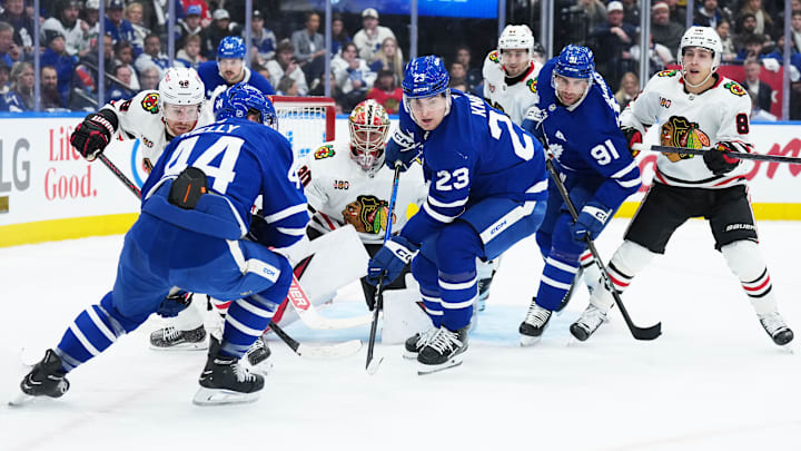 Dec 16, 2025; Toronto, Ontario, CAN; Toronto Maple Leafs left wing Matthew Knies (23) battles for the puck in front of Chicago Blackhawks goaltender Spencer Knight (30) during the first period at Scotiabank Arena. Mandatory Credit: Nick Turchiaro-Imagn Images