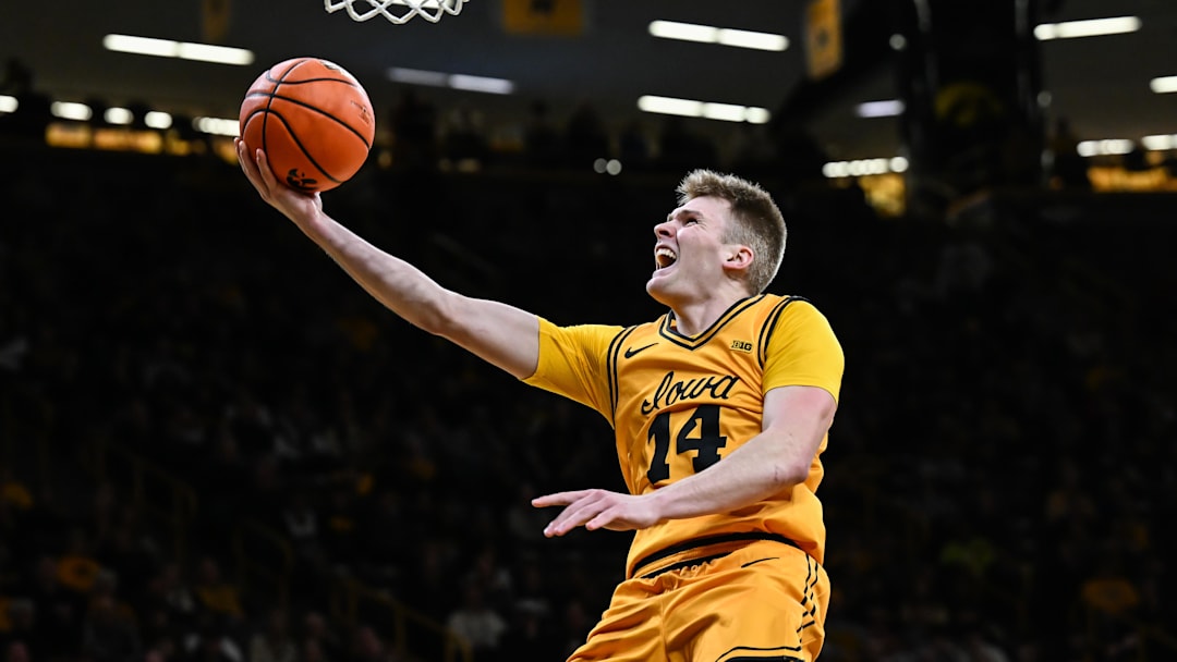 Feb 25, 2026; Iowa City, Iowa, USA; Iowa Hawkeyes guard Bennett Stirtz (14) goes to the basket against the Ohio State Buckeyes during the second half at Carver-Hawkeye Arena. Mandatory Credit: Jeffrey Becker-Imagn Images