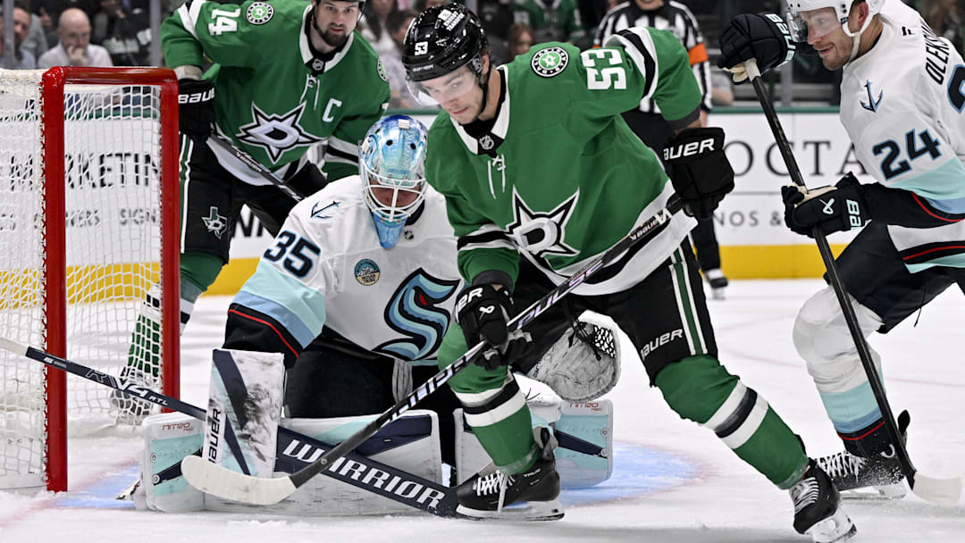 Feb 25, 2026; Dallas, Texas, USA;  Dallas Stars center Wyatt Johnston (53) looks to push the puck past Seattle Kraken goaltender Joey Daccord (35) during the second period at the American Airlines Center. Mandatory Credit: Jerome Miron-Imagn Images