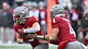 Oct 25, 2025; Pullman, Washington, USA; Washington State Cougars running back Kirby Vorhees (9) takes the hand off from Washington State Cougars quarterback Zevi Eckhaus (4) against the Toledo Rockets in the first half at Gesa Field at Martin Stadium. Mandatory Credit: James Snook-Imagn Images